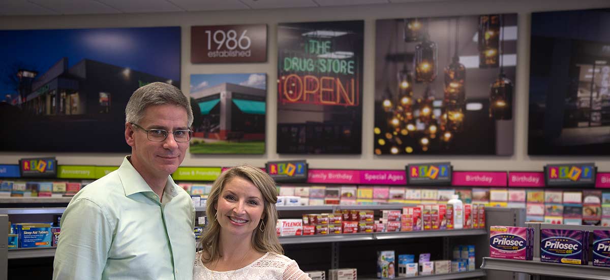 Phillip and Holly Judd of The Drug Store, with the new picture wall in the background