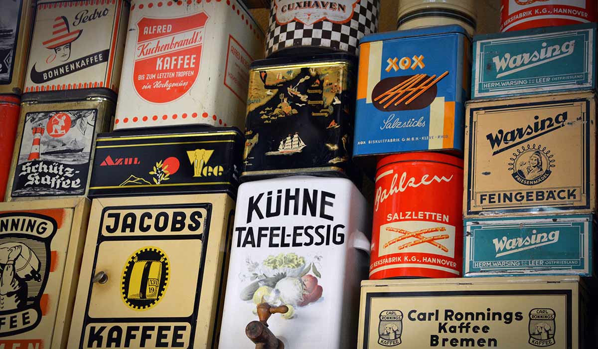 Old coffee containers with various brand names on them