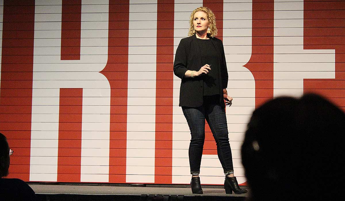 Alli Worthington on stage at Tribe Conference