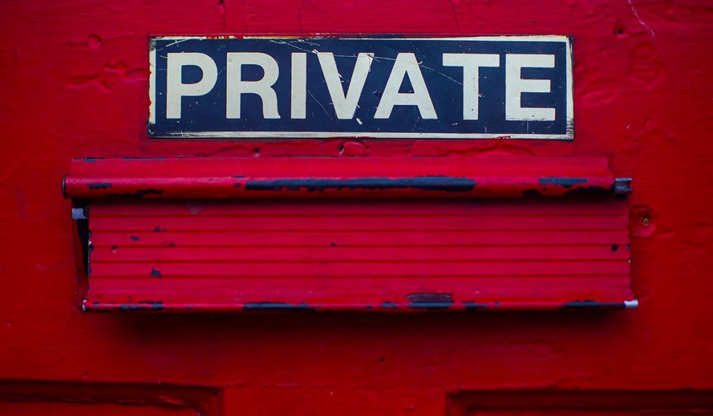 Sign "private" over a mail drop on a door