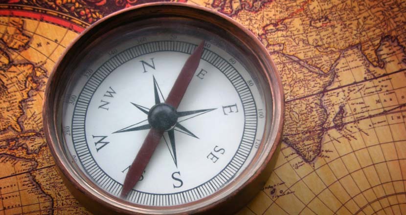Compass on an old world map