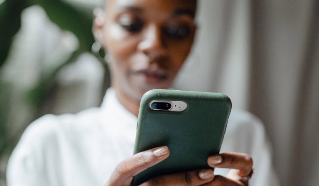 African-American woman looking at website on her phone