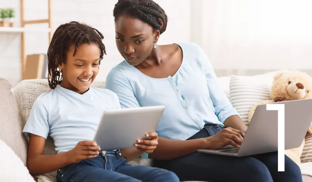 mom and daughter looking at computer screens